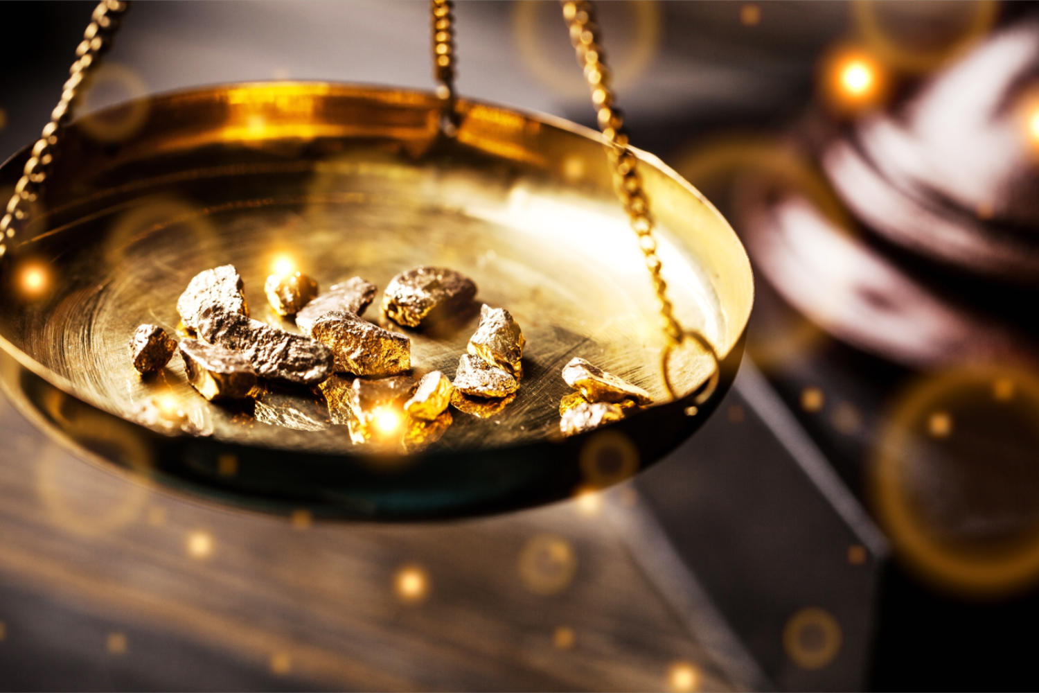 Foto: Goldnuggets in einer Messingwaagschale