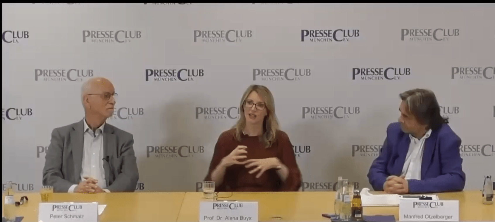 Screenshot einer Pressekonferenz im PresseClub München mit Alena Buyx in der Mitte des Podiums